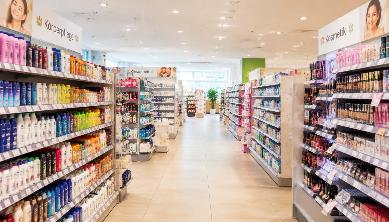 A bright European drugstore aisle full of products